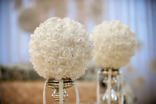 Gold table centerpieces with white ball flowers with diamonds at wedding reception