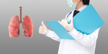 Doktor gri arka planda akciğere sembol gibi bir şey yapar