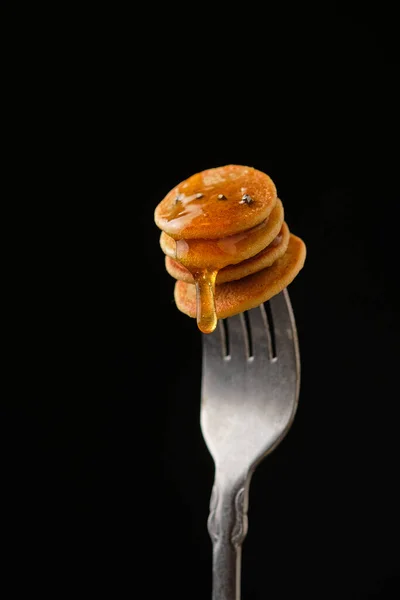 Mini Pfannkuchen Mit Honig Auf Einer Gabel Vor Dunklem Hintergrund — Stockfoto