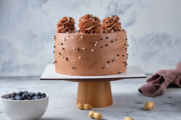 Chocolate sponge cake stuffed with salted caramel and peanuts. Cake with cream cheese chocolate cream.