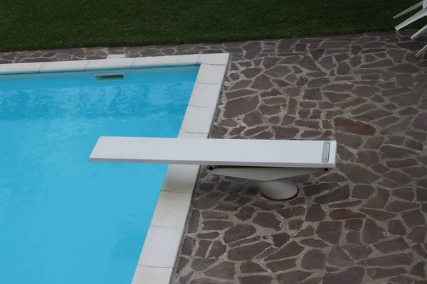 outdoor swimming pool with diving board