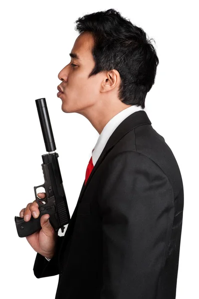 Business man Aziatische houden pistool in pak isolaten — Stockfoto