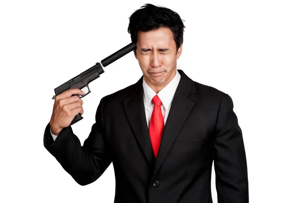 Uomo d'affari asiatico tenere pistola in tuta isolato Foto Stock Royalty Free