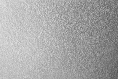 Beyaz beton duvar arkaplanının kaba deseninde ışık ve gölge