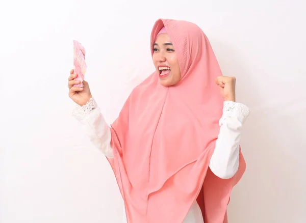 Happy Asian Woman Muslim Dress Stands Holding Indonesian Money Isolated — Φωτογραφία Αρχείου