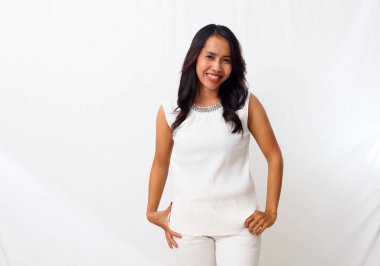 Beyaz duvara gülümseyen Asyalı genç bir kadının portresi.