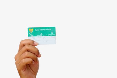 Yogyakarta, Indonesia - Mar 10, 2021 : Hand holds Kartu Indonesia Sehat(KIS) or Indonesia Health Card, Health Insurance card from the Government of Indonesia