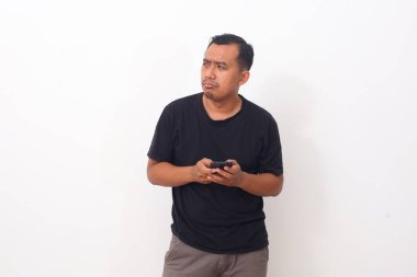 Asyalı Adam, yan yan bakarken akıllı telefondan izlediği programdan nefret eder ve iğrenir. Beyaz arkaplanda izole