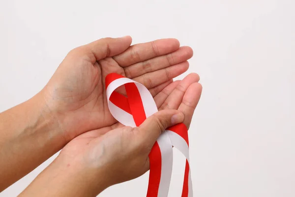 Human Hand Holds Red White Ribbon Symbol Indonesian Flag Isolated — Stock Photo, Image