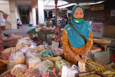 Yogyakarta, Indonesia - Jul 6, 2021 : the atmosphere of a trader in a traditional market during the corona virus pandemic clipart