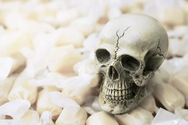 Still life of human skull with candy