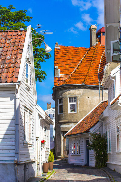 Old street with white wooden houses with tiled roofs in the cent