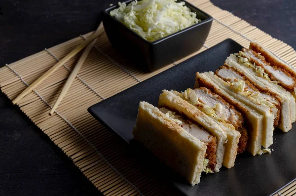 Katsu sandos japanese sandwich with chicken or pork chop, cabbage and tonkatsu sauce.