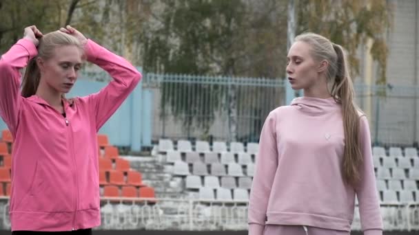 Caucasien identiques jolis jumeaux en vêtements de sport faire des exercices de sport au stade — Video