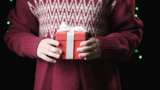 Childs hands giving red box with white ribbon. christmas, new year concept — Stock Video