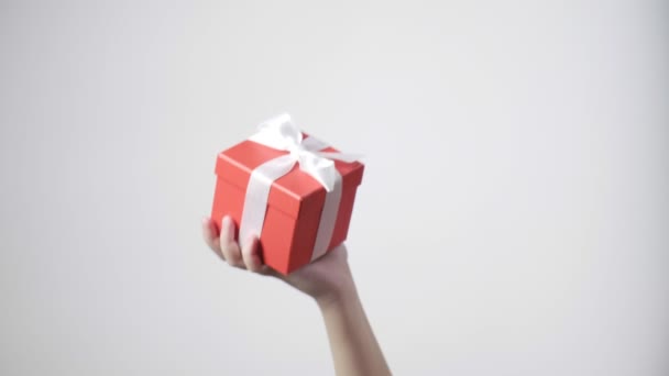 Childs hand holds red gift with ribbon. christmas, new year, birthday surprise — Stock Video