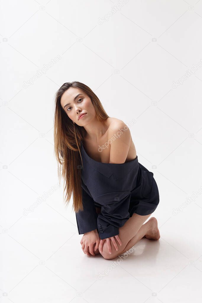 young attractive asian woman in blue suit isolated on white studio background