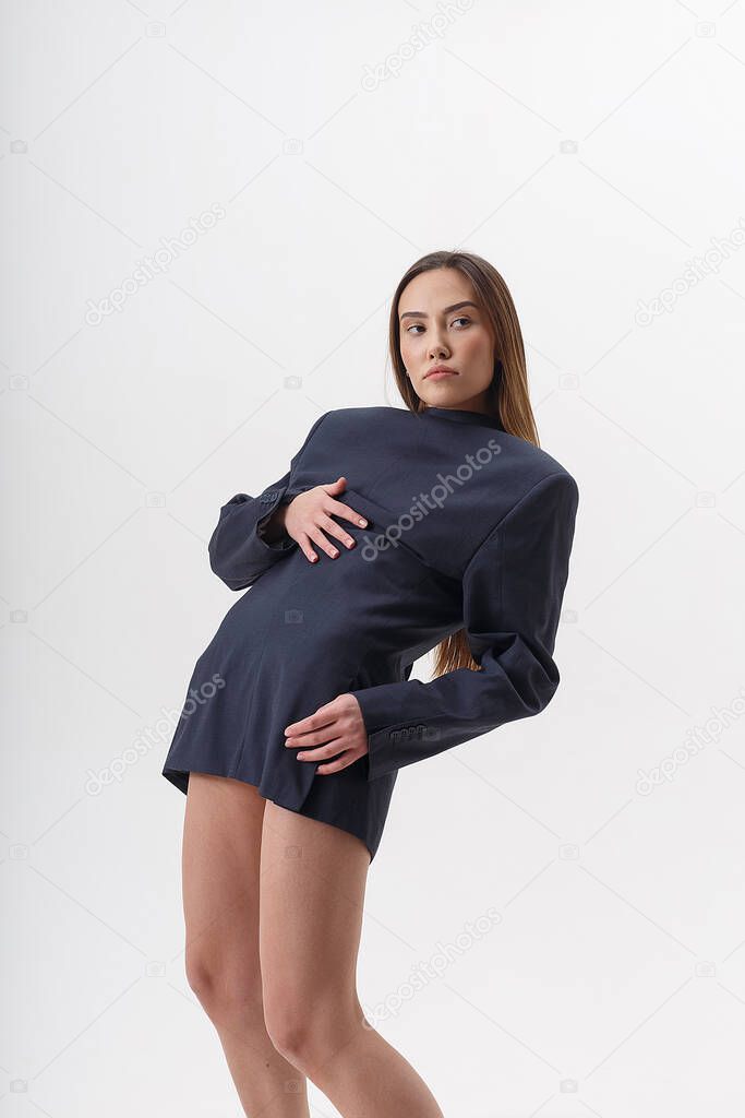 young attractive asian woman in blue suit isolated on white studio background