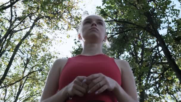 Бігунка в спортивному одязі в осінньому парку в сонячний день — стокове відео