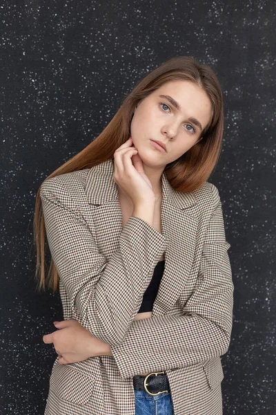 Young attractive caucasian woman with long hair in black top and suit jacket — Stock Photo, Image