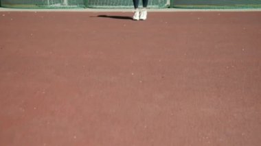 Spor giyimli genç bir kadın atlama egzersizinde ip atlıyor.