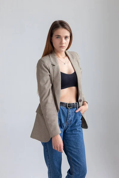 Young attractive caucasian woman with long brown hair in suit jacket at studio — Stock Photo, Image