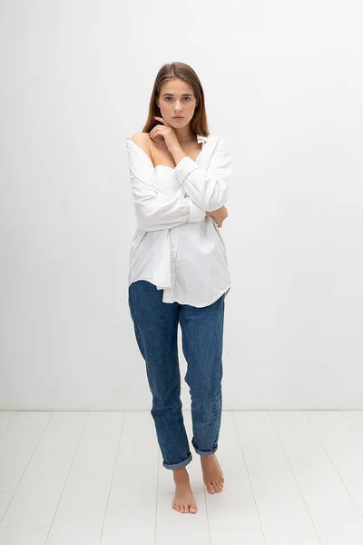 Jovem mulher caucasiana atraente com cabelo castanho longo na camisa, jeans azul — Fotografia de Stock