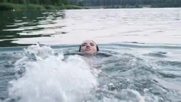 Fiatal vonzó nyugodt ázsiai nő úszik tó vagy tó a hátán — Stock videók
