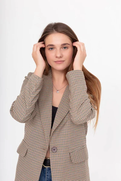 Young attractive caucasian woman with long brown hair in suit jacket at studio — Stock Photo, Image