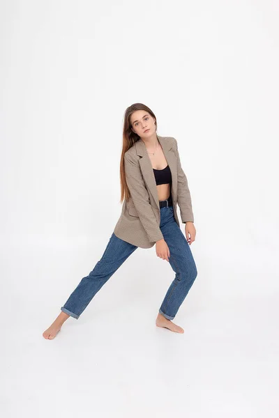 Young caucasian woman with long brown hair in suit jacket on white background — Stock Photo, Image