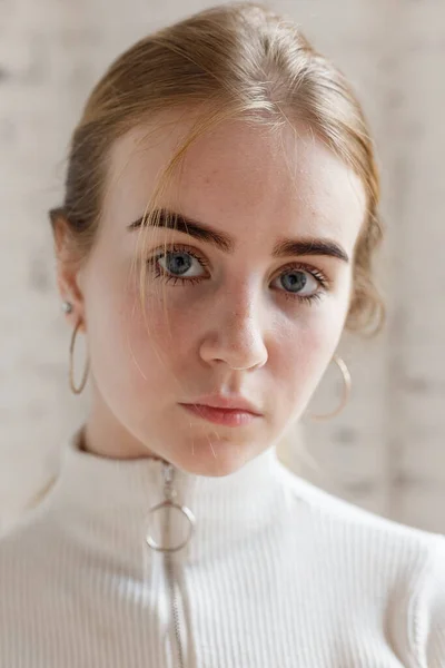 Zbliżenie portret przemyślany nastolatek model z niebieskimi oczami noszenie biały sweter — Zdjęcie stockowe