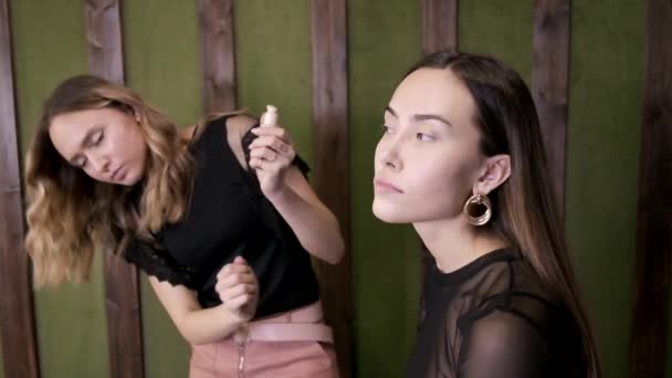 Makeup artist applies base tone cream on asian girls face at beauty salon — Stock Video