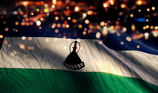 Lesotho nationale Flagge Licht Nacht Bokeh abstrakten Hintergrund — Stockfoto
