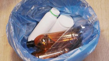 Plastic bottle is thrown into the trash bin