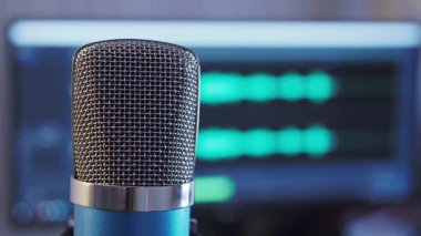 Close-up microphone with waveform in the background