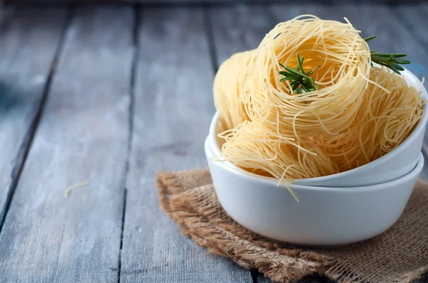 Nest of pasta into a bowl — Stock Photo, Image