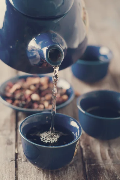 Tea being poured into cup. Toned photo — Stock Photo, Image