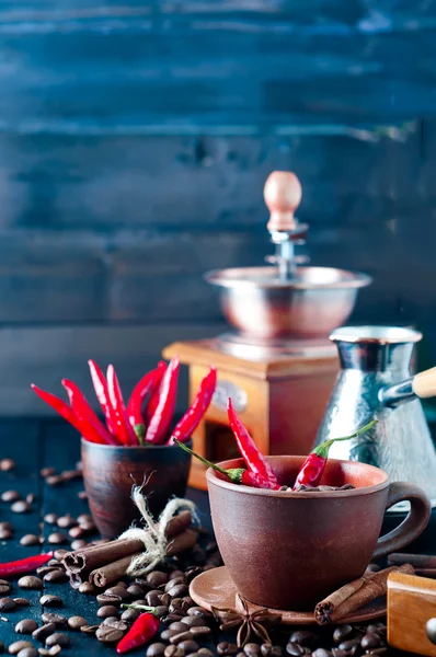 Coffee beans and red chilly peppers — Stock Photo, Image