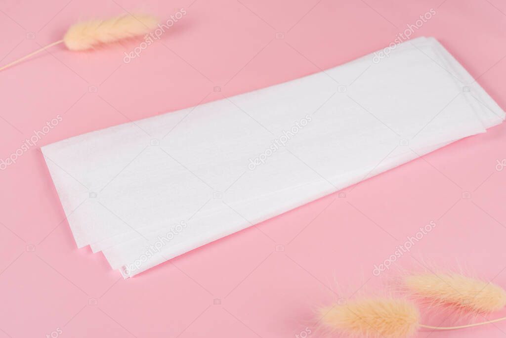 Wax strips for epilation on pink background