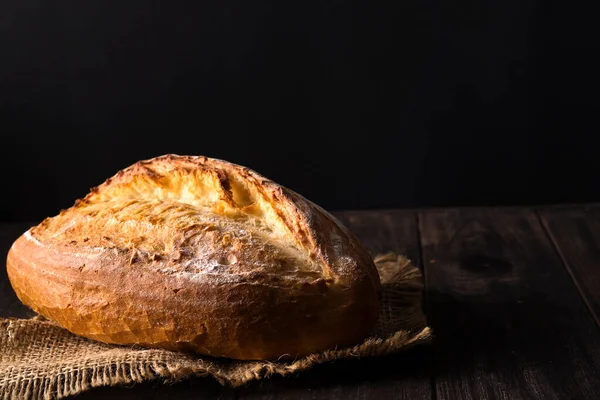 パン屋さん 金パンと黒の背景にパンの素朴な無愛想なパン 上記のコピーの領域キャプチャのある静物 — ストック写真