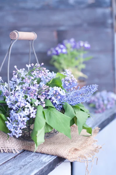 Summer lilac flowers in basketon — Stock Photo, Image