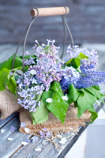 Summer lilac flowers in basketon — Stock Photo, Image