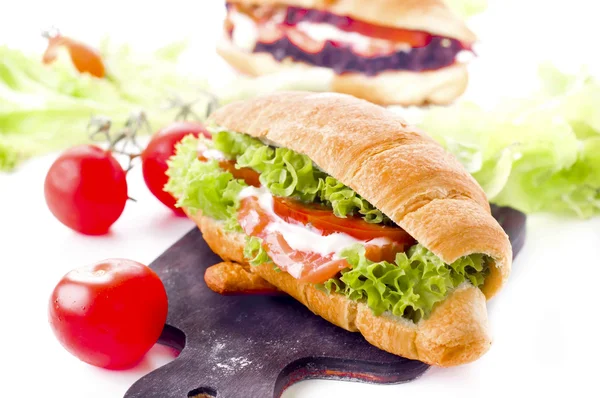 Croissant sandwich with salted salmon on plate, — Stok fotoğraf