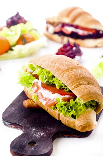 Croissant sandwich with salted salmon on plate, — Stok fotoğraf