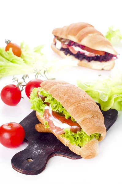 Croissant sandwich with salted salmon on plate, — Stok fotoğraf