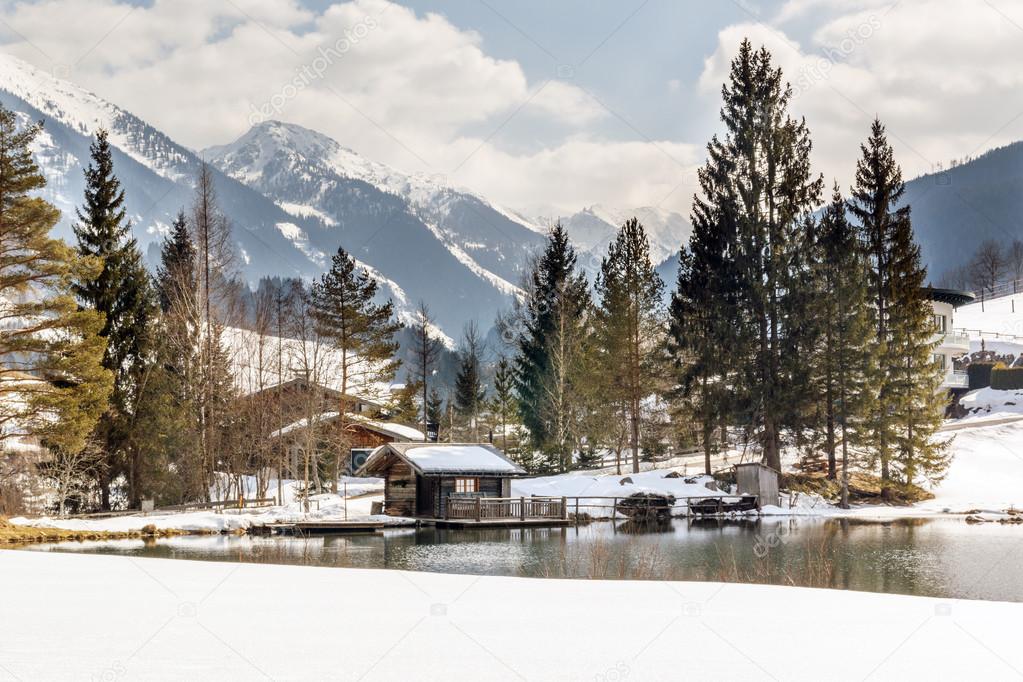 Landscape view of wooden house, lake and mountains