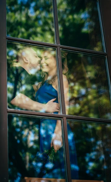 Lovely young couple in the window. — Stok fotoğraf