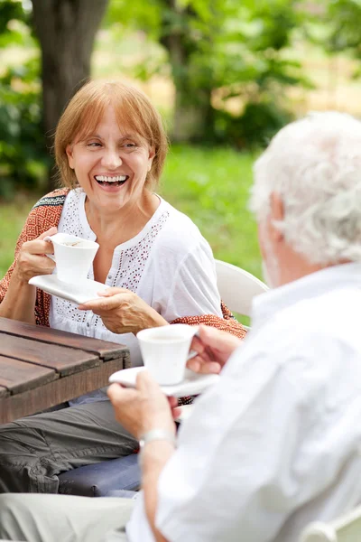 Senior couple enjoying cup of coffee outdoors — Stock Photo, Image