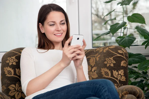 Jovem mulher usando telefone celular — Fotografia de Stock