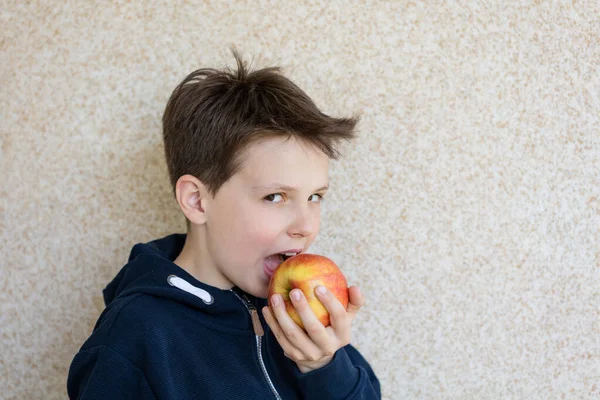 10歳の少年がリンゴを味わう姿 — ストック写真